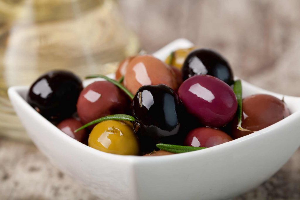 multi-colored olives in small white dish low carb snacks