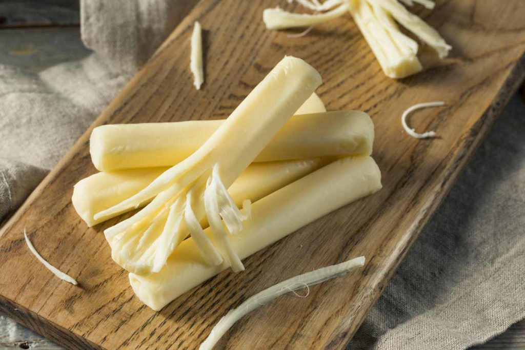 string cheese on wood cutting board