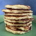 stack of cauliflower patties on green plate