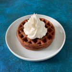 two chocolate chaffles on plate with whipped cream