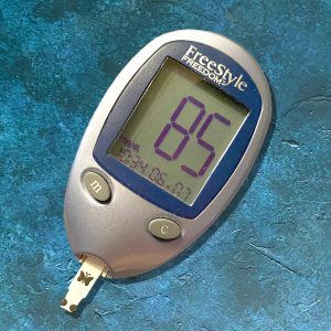 blood glucose meter with 85 reading