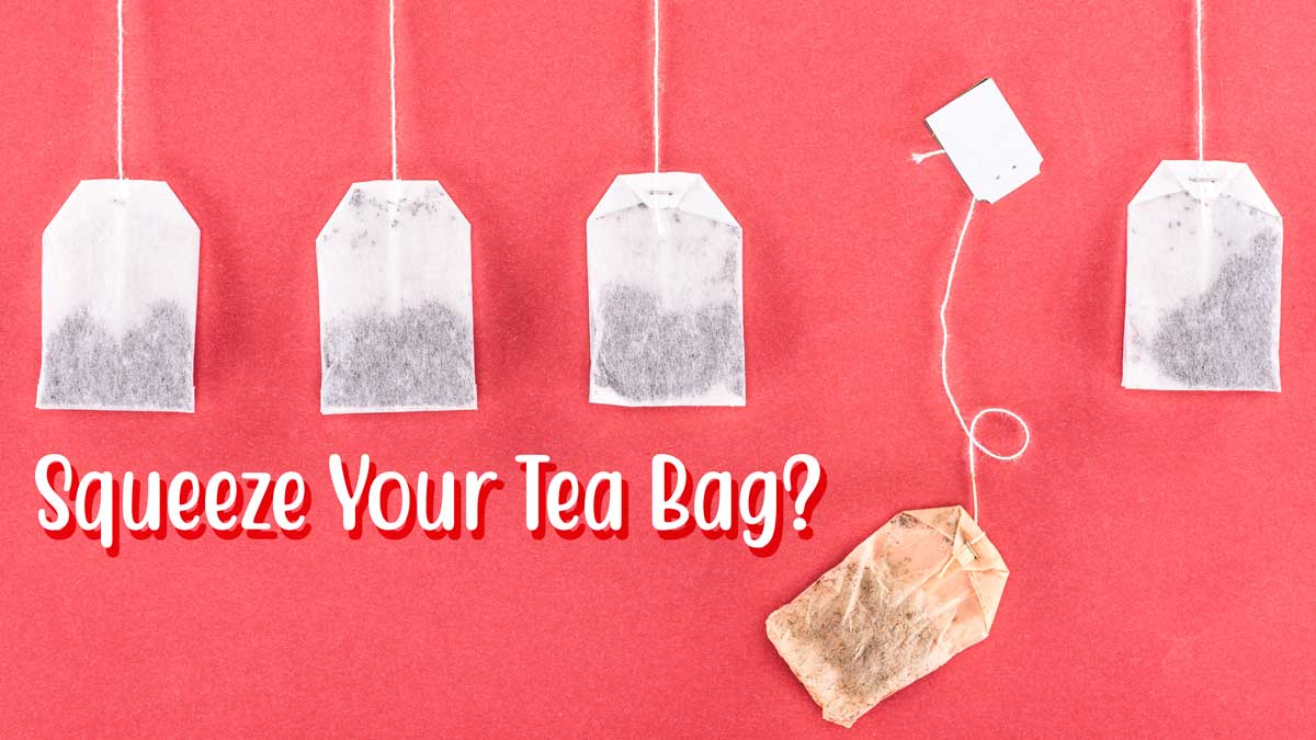 tea bags hanging on pink background