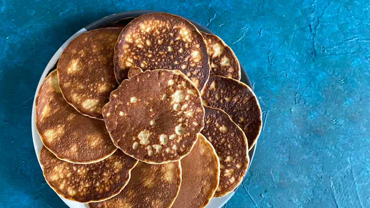 Plate of low fat almond flour pancakes on a blue background